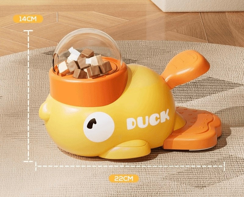 Yellow duck treat dispenser showing the chamber and orange press plate