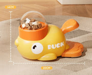 Yellow duck treat dispenser showing the chamber and orange press plate