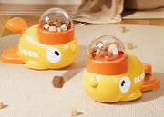 Two yellow duck treat dispensers with clear snack chambers