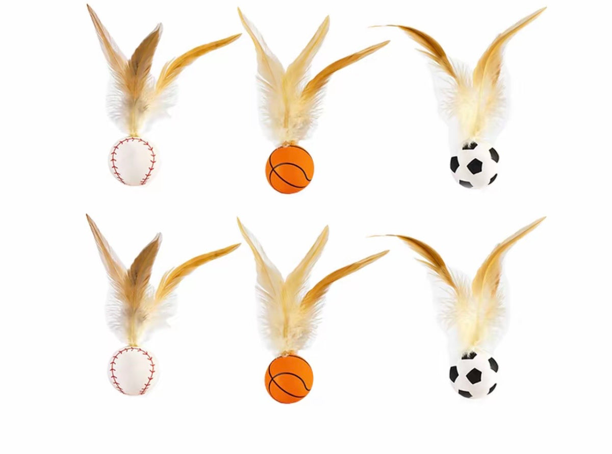 Six feather-topped cat balls in baseball, basketball and soccer designs