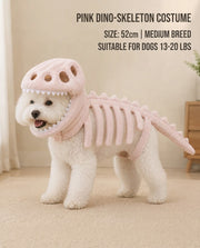Small dog wearing a pink dinosaur skeleton costume