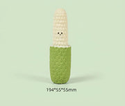 Corn-shaped squeaky dog toy with a green textured base